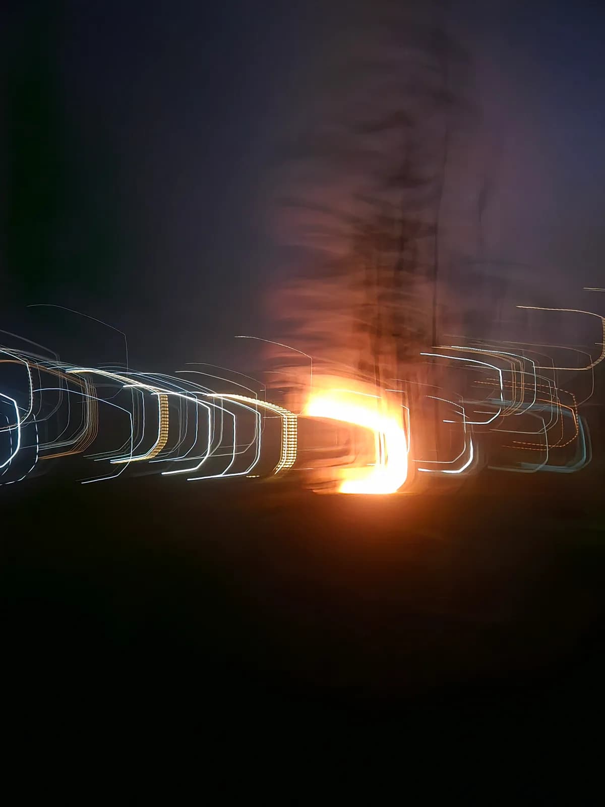 A long exposure of a fire and streaked lights at night in Sapa